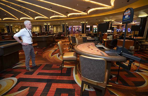 Rich Broome, executive vice president of community and government relations for Caesars Entertainment. looks over the casino floor during a tour of Caesars Palace Thursday, May 21, 2020. Seating at gaming tables, like the one at right, will be reduced from six people to three people, he said.
