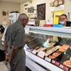 Mark Madril, customer service assistant manager, helps customer Al Philmon at Larry's Great Western Meats, 420 S. Valley View Blvd., Thursday, May 21, 2020.