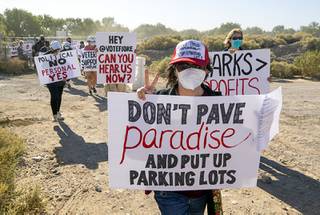 Protestors walk to an opening ceremony for mountain bike trails and a BMX pump track at Floyd Lamb Park at Tule Springs Saturday, May 23, 2020. Protesters are opposed to plans to convert a barn at the park into an events center.