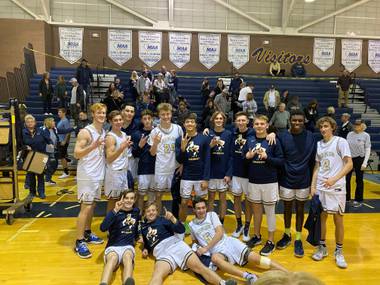 The Boulder City basketball team celebrates a triple overtime victory against Sunrise Mountain to earn a spot in the 3A state basketball tournament.