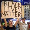 Photo: Protesters hold up signs and chant at Metro Police