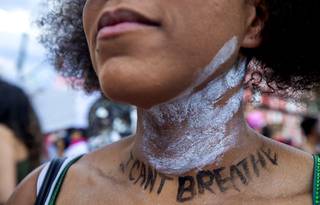 Rochelle Abney wears a handprint on her neck and the words 