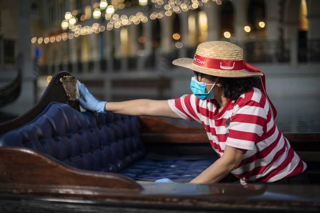 A Venetian team member sanitizes a gondola.