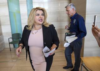 Las Vegas City Councilwoman Michele Fiore leaves a news conference after stepping down as Mayor Pro Tem at Las Vegas City Hall Tuesday, June 16, 2020. David Riggleman, city communications director, is at right.
