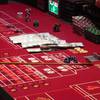 This June 24, 2016 photo shows cash, chips and dice on a craps table during a game at the Golden Nugget casino in Atlantic City, N.J.
