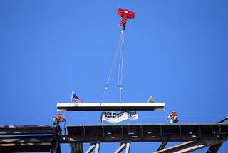 Ironworkers guide the final beam into place during a topping out ceremony for Circa in downtown Las Vegas Friday, June 19, 2020. The hotel-casino, the first new ground-up casino built in downtown Las Vegas since 1980, is expected to open Oct. 28, 2020. STEVE MARCUS