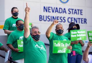 Harry Schiffman, left, president of the American Federation of State County Municipal Employees (AFSCME) union, local 4041, speaks during a rally in front of the Nevada State Business Center on West Sahara Avenue Saturday, June 27, 2020. AFSCME members say Governor Steve Sisolak violated a 2019 collective bargaining statute by refusing to negotiate the furloughs and salary freezes enacted to cut spending amid the coronavirus pandemic.