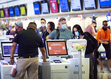 While waiting for her luggage at McCarran International Airport, Christina Esposito of San Diego said she was concerned about traveling in the midst of the coronavirus outbreak. But she and her friend were on a mission, headed to South Dakota to buy ...