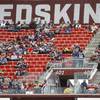 In this Oct. 6, 2019, file photo, fans watch play between the Washington Redskins and the New England Patriots during the second half of an NFL football game, in Landover, Md.