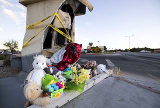 Stuffed animals and flowers are shown at a makeshift memorial near the intersection of Rampart at Lake Mead boulevards Tuesday, July 14, 2020. One-year-old Royce Jones was killed in a traffic accident at the site Sunday.