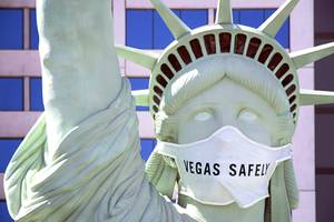 The Statue of Liberty outside of New York-New York sporting a 'Vegas  Safely' mask