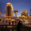 In this Jan. 12, 2015, file photo, a man takes pictures of Caesars Palace hotel and casino in Las Vegas.