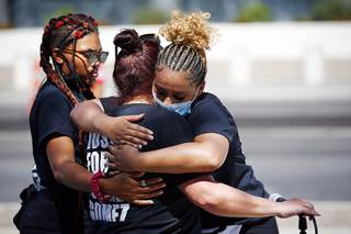 Jeanne Llera, center, mother of Jorge Gomez, is consoled by Zyera Dorsey, left, and Desiree Smith following a news conference and march at the Lloyd George Federal Courthouse in downtown Las Vegas Wednesday, July 22, 2020. Gomez was shot and killed by Metro Police officers in front of the courthouse during a George Floyd protest on June 1, 2020.