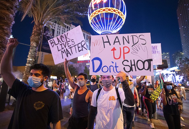 Protesters march on the Las Vegas Strip Friday, July 25, ...