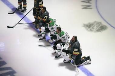 Dallas Stars’ Jason Dickinson (18), Tyler Seguin (91) and Golden Knights’ Ryan Reaves (75) and goalie Robin Lehner (90) take a knee during the national anthem prior to an NHL playoff game Monday, Aug. 3, 2020 in Edmonton, Alberta. 