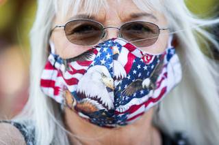 Nancy Cooley wears a handmade patriotic face mask during a rally against Assembly Bill 4 at the Sawyer State Building Tuesday, Aug. 4, 2020. The bill, signed by governor Steve Sisolak on Monday, will expand mail-in ballot provisions but it does not do away with in-person voting locations.