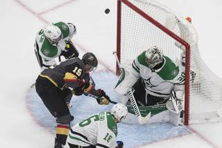 Dallas Stars goalie Ben Bishop (30) makes a save on Vegas Golden Knights' Reilly Smith (19) during the third period of an NHL hockey playoff game Monday, Aug. 3, 2020, in Edmonton, Alberta. (Jason Franson/The Canadian Press via AP)