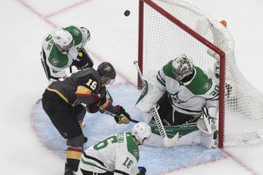 Dallas Stars goalie Ben Bishop (30) makes a save on Vegas Golden Knights’ Reilly Smith (19) during the third period of an NHL hockey playoff game Monday, Aug. 3, 2020, in Edmonton, Alberta. (Jason Franson/The Canadian Press via AP)