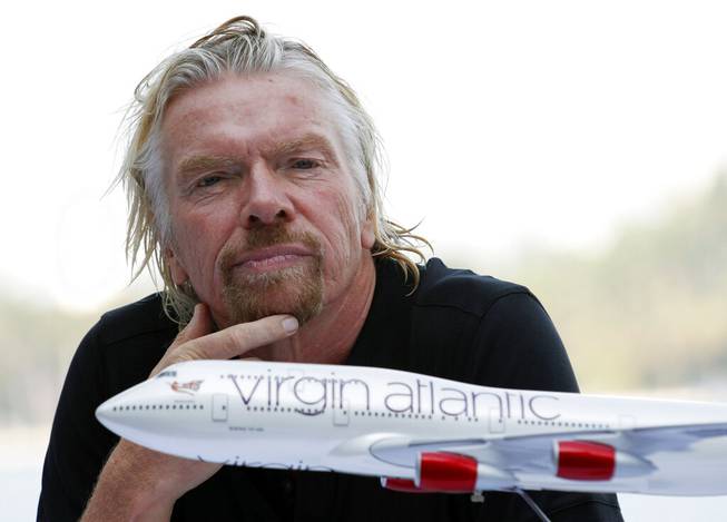 In this June 16. 2011, file photo, Richard Branson, president of Virgin Atlantic Airways, attends a news conference in Miami Beach, Fla. Branson announced that Virgin was starting flights between London and Cancun, Mexico. Virgin Atlantic, the airline founded by British businessman Branson, filed Tuesday, Aug. 4, 2020, for relief from creditors as the virus pandemic hammers the airline industry. The airline made the filing in U.S. federal bankruptcy court in New York after a proceeding in the United Kingdom. 