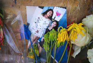 A photo of Citlali Mora, left, and Nelly Amaya Ramirez is shown at a makeshift memorial on Maryland Parkway at Katie Avenue Wednesday, Aug. 5, 2020. The Del Sol High School students were killed by an alleged impaired driver.