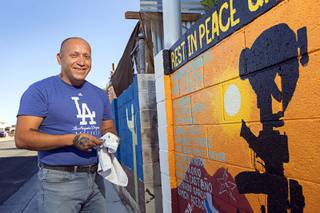 Marine veteran Cesar Lopez poses by a mural on a wall outside his home Wednesday, Aug. 12, 2020. Lopez, a legal resident but not a U.S. citizen, was deported to Mexico based on a conviction from 2000. He now works on behalf of other veterans who have been deported.
