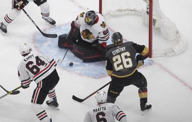 Chicago Blackhawks goalie Corey Crawford (50) makes the save on Vegas Golden Knights’ Paul Stastny (26) during the second period in Game 1 of an NHL hockey Stanley Cup first-round playoff series, Tuesday, Aug. 11, 2020, in Edmonton, Alberta. (Jason Franson/The Canadian Press via AP)