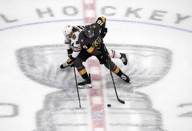 Vegas Golden Knights’ Nicolas Roy (10) and Chicago Blackhawks’ Duncan Keith (2) battle for the puck during the first period of a first-round NHL Stanley Cup playoff hockey series in Edmonton, Alberta, Thursday, Aug. 13, 2020. (Jason Franson/The Canadian Press via AP)