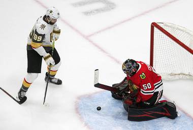 Vegas Golden Knights’ Alex Tuch (89) is stopped by Chicago Blackhawks goalie Corey Crawford (50) during the second period of an NHL hockey Stanley Cup first-round playoff series, Saturday, Aug. 15, 2020, in Edmonton, Alberta.