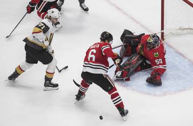 Vegas Golden Knights’ William Karlsson (71) is stopped by Chicago Blackhawks goalie Corey Crawford (50) as Olli Maatta (6) defends during the second period in Game 4 of an NHL hockey first-round playoff series Sunday, Aug. 16, 2020, in Edmonton, Alberta. (Jason Franson/The Canadian Press via AP)