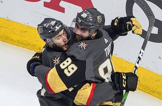 Vegas Golden Knights' Nicolas Roy (10) and Alex Tuch (89) celebrate a goal against the Chicago Blackhawks during the third period in Game 5 of an NHL hockey first-round playoff series, Tuesday, Aug. 18, 2020, in Edmonton, Alberta.