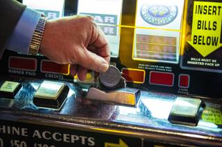 Adam Wiesberg, General Manager of the El Cortez, places a token in a coin slot machine, Wednesday, Aug. 19, 2020.