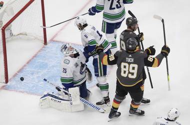 Vegas Golden Knights’ Reilly Smith (19) and Alex Tuch (89) celebrate a goal as Vancouver Canucks goalie Jacob Markstrom (25) reacts during the second period in Game 1 of an NHL hockey second-round playoff series, Sunday, Aug. 23, 2020, in Edmonton, Alberta. (Jason Franson/The Canadian Press via AP)