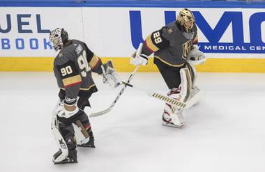 Vegas Golden Knights goalie Robin Lehner (90) and goalie Marc-Andre Fleury (29) tap sticks during warm-up before NHL Western Conference Stanley Cup playoff action against the Vancouver Canucks, in Edmonton, Alberta, Sunday, Aug. 23, 2020. (Jason Franson/The Canadian Press via AP)