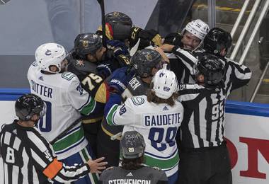 Vegas Golden Knights’ Ryan Reaves (75) and Vancouver Canucks’ Antoine Roussel (26) rough it up during the third period in Game 1 of an NHL hockey second-round playoff series, Sunday, Aug. 23, 2020, in Edmonton, Alberta. (Jason Franson/The Canadian Press via AP)