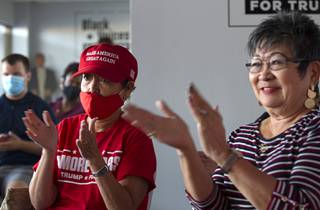 Evelyn Sayre, left, and Michele Barnes applaud during a Republican National Convention watch party at the Black Voices Community Center, a Trump Victory field office, on North Decatur Boulevard Tuesday, Aug. 25, 2020. The woman were applauding as President Trump granted a pardon to Las Vegan Jon D. Ponder, founder and CEO of Hope for Prisoners, for his work to reintegrate formerly incarcerated people back into society.