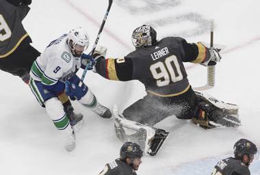 Vegas Golden Knights goalie Robin Lehner (90) tries to stop Vancouver Canucks’ J.T. Miller (9) during the second period of Game 2 of an NHL hockey second-round playoff series, Tuesday, Aug. 25, 2020, in Edmonton, Alberta. (Jason Franson/The Canadian Press via AP)