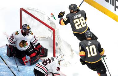 Chicago goalie Corey Crawford looks back after a goal by Vegas’ William Carrier (28) during Game 1 of the teams’ first-round playoff series.