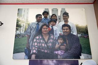 An undated family photo is shown on the wall in the Tia family apartment Wednesday, Aug. 26, 2020. Eric Tia, the oldest son, was fatally stabbed at an illegal pool party on July 22. His father Elika Tia died 10 days later due to a heart condition.