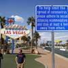 In this March 21, 2020, file photo, a sign advises people to practice social distancing to slow the spread of the coronavirus at the "Welcome to Fabulous Las Vegas Nevada" sign amid a shutdown of casinos along the Las Vegas Strip in Las Vegas.