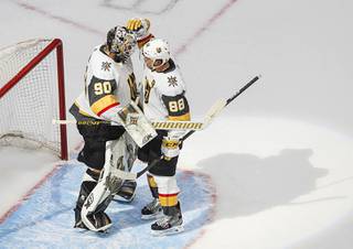 Vegas Golden Knights goalie Robin Lehner (90) and teammate Nate Schmidt (88) celebrate the team's win over the Vancouver Canucks in Game 3 of an NHL hockey second-round playoff series, Saturday, Aug. 29, 2020, in Edmonton, Alberta.