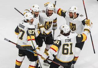 Vegas Golden Knights' Shea Theodore (27), Max Pacioretty (67), Mark Stone (61), Paul Stastny (26) and Jonathan Marchessault (81) celebrate a goal by Pacioretty against the Vancouver Canucks during the first period of an NHL Western Conference Stanley Cup playoff game, Sunday, Aug. 30, 2020, in Edmonton, Alberta.