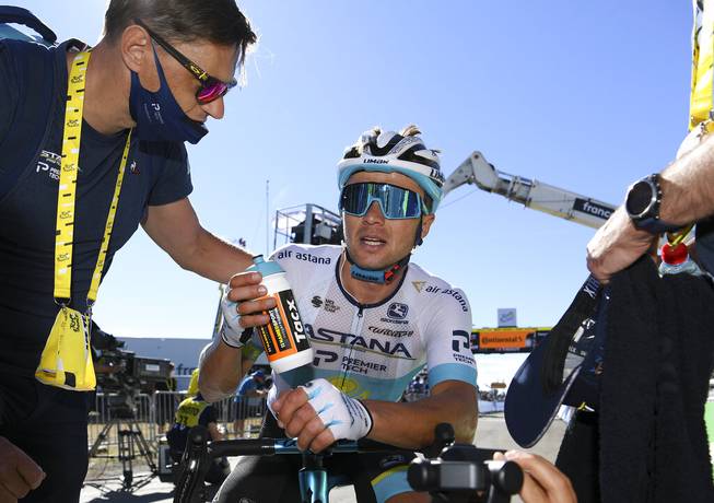 Kazakhstan's Alexey Lutsenko rests after winning the sixth stage of the Tour de France cycling race over 191 kilometers from Le Teil to Mt. Aigoual Thursday, Sept. 3, 2020.