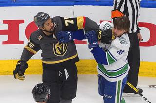 Vancouver Canucks' Jake Virtanen (18) and Vegas Golden Knights' Ryan Reaves (75) rough it up during the first period of Game 7 of an NHL hockey second-round playoff series, Friday, Sept. 4, 2020, in Edmonton, Alberta.