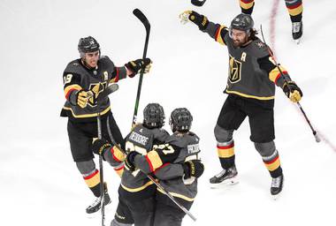 Vegas Golden Knights’ Shea Theodore (27) celebrates his goal against the Vancouver Canucks with teammates Reilly Smith (19), Jonathan Marchessault (81) and Max Pacioretty (67) during the third period of Game 7 of an NHL hockey second-round playoff series, Friday, Sept. 4, 2020, in Edmonton, Alberta.