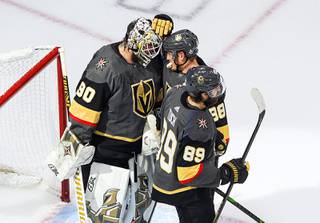 Vegas Golden Knights goalie Robin Lehner (90) and teammates Nate Schmidt (88) and Alex Tuch (89) celebrate the team's 3-0 win over the Dallas Stars in Game 2 of the NHL hockey Western Conference final, Tuesday, Sept. 8, 2020, in Edmonton, Alberta.