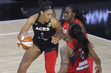 Las Vegas Aces’ A’ja Wilson, left, backs into the defense of Atlanta Dream’s Shekinna Stricklen during the first half of a WNBA basketball game Saturday, Sept. 5, 2020, in Bradenton, Fla. (AP Photo/Mike Carlson)