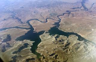 This Sept. 11, 2019 photo shows an aerial view of Lake Powell on the Colorado River along the Arizona-Utah border. Environmental groups that have long pushed to bring down a huge Colorado River dam and are suing the federal government. They say in a lawsuit filed Tuesday, Oct. 1, 2019, in U.S. District Court in Arizona that the U.S. Bureau of Reclamation ignored climate science when approving a 20-year operating plan for Glen Canyon Dam. The dam holds back Lake Powell, one of the largest man-made reservoirs in the country. (AP Photo/John Antczak)