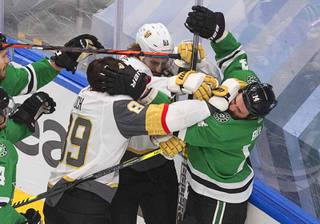 Dallas Stars' Jamie Benn (14) and Vegas Golden Knights' Alex Tuch (89) and Mark Stone (61) battle along the boards during the first period of Game 3 of the NHL hockey Western Conference final, Thursday, Sept. 10, 2020, in Edmonton, Alberta.
