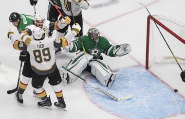 Dallas Stars goalie Anton Khudobin (35) gives up a goal as Vegas Golden Knights’ Mark Stone (61) and Alex Tuch (89) celebrate Tuch’s goalduring the third period of Game 3 of the NHL hockey Western Conference final, Thursday, Sept. 10, 2020, in Edmonton, Alberta. (Jason Franson/The Canadian Press via AP)