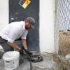 Ross Hunsaker, service manager for Progressive Pest Control, checks on a rat bait station at a business in Henderson Friday, Sept. 11, 2020.